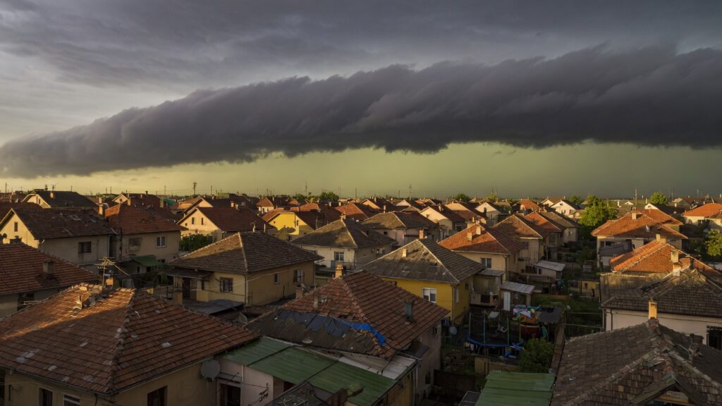 Storm light over suburban rooftops